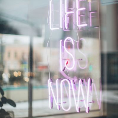 Neon lights reflecting on a glass wall in studio